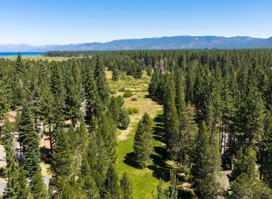 Nestled amidst a dense forest of towering pine trees, this property offers a serene and private retreat.