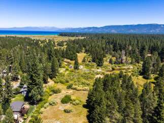 Experience the serene beauty of this expansive property, nestled amidst a lush pine forest with a meandering creek.