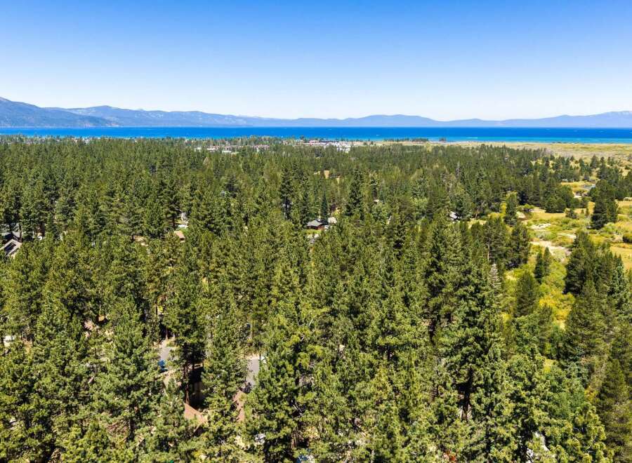 Experience the serene beauty of Lake Tahoe from this stunning property nestled amidst a lush pine forest.