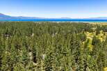 Experience the serene beauty of Lake Tahoe from this stunning property nestled amidst a lush pine forest.