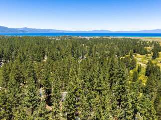 Experience the serene beauty of Lake Tahoe from this stunning property nestled amidst a lush pine forest.