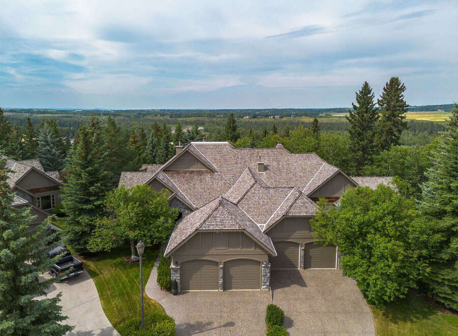 Experience luxury living in this stunning mountain-style home, nestled amidst mature trees and offering breathtaking panoramic views.