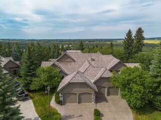 Experience luxury living in this stunning mountain-style home, nestled amidst mature trees and offering breathtaking panoramic views.