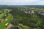 Experience luxury living nestled amidst a pristine golf course and lush forest.