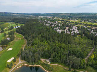 Experience luxury living nestled amidst a pristine golf course and lush forest.