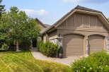 Discover this charming home featuring a welcoming stone-accented exterior and a well-maintained lawn.