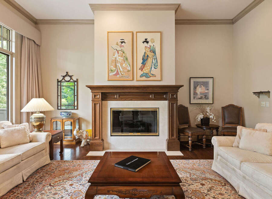 Step into this elegant living room, featuring a grand fireplace as the focal point, flanked by two exquisite Japanese-inspired artworks.