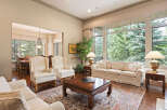 Step into this elegant living room, featuring plush cream-colored seating and a large, ornate coffee table perfect for gatherings.