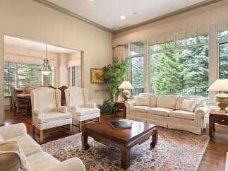 Step into this elegant living room, featuring plush cream-colored seating and a large, ornate coffee table perfect for gatherings.