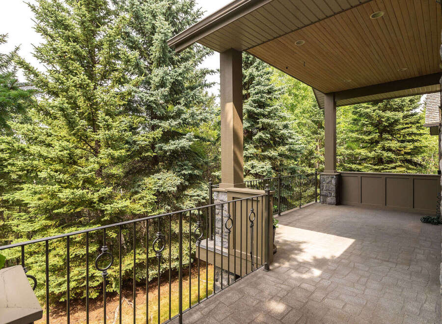 Enjoy the serene beauty of nature from this expansive covered porch, perfect for outdoor living and entertaining.