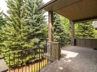 Enjoy the serene beauty of nature from this expansive covered porch, perfect for outdoor living and entertaining.
