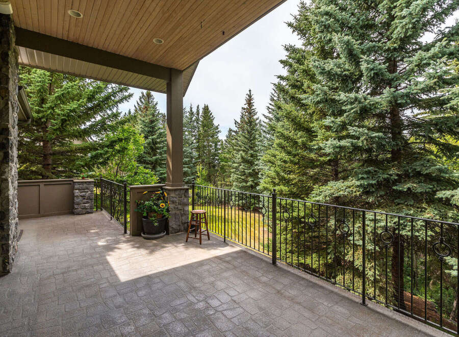 Enjoy the serene beauty of nature from this expansive covered balcony, perfect for outdoor living and entertaining.