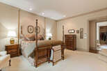Step into this luxurious master suite, featuring a grand four-poster bed as the centerpiece.