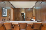 Step into this beautifully appointed home bar, featuring rich wood paneling and a spacious counter perfect for entertaining.
