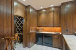Discover this exquisite wine cellar featuring rich, dark wood paneling and a diamond-patterned wine rack, perfect for showcasing your collection.