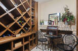 Discover this exquisite wine cellar, featuring a custom-built wooden wine rack with diamond-shaped compartments, perfect for storing your prized collection.
