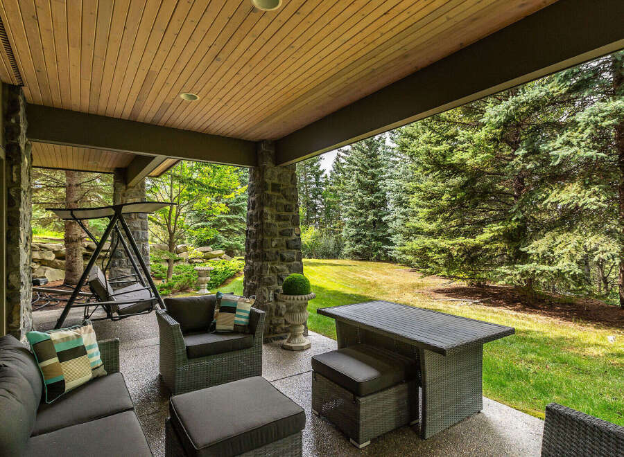 Enjoy outdoor living on this covered patio, perfect for relaxing or entertaining.