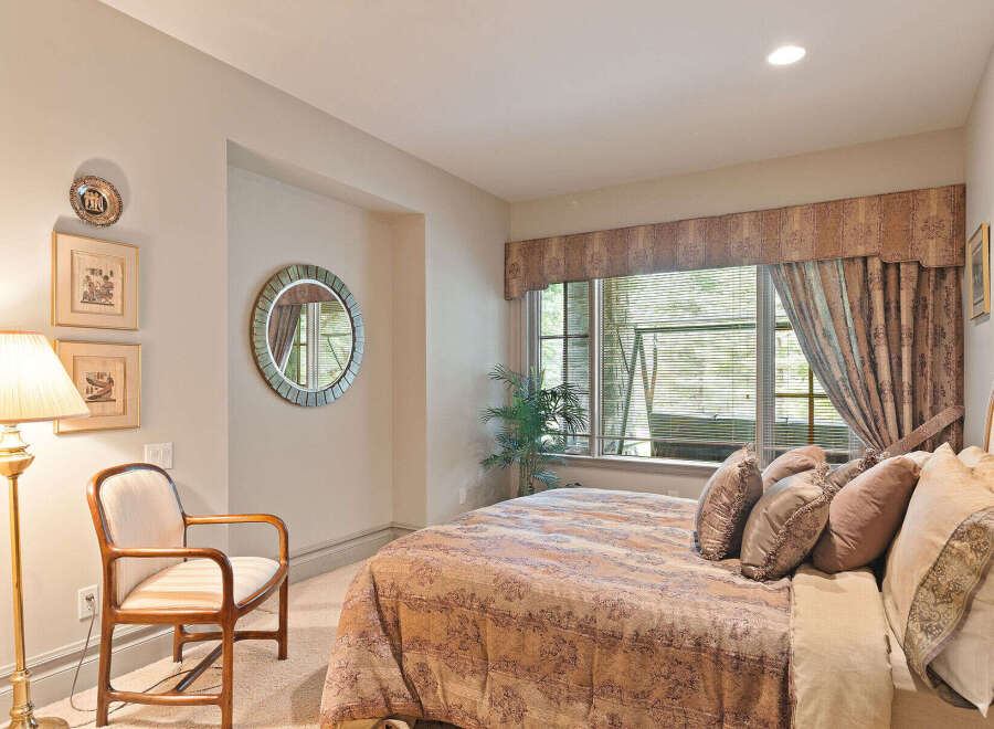This inviting bedroom features a plush king-sized bed adorned with decorative pillows, perfect for a restful night's sleep.