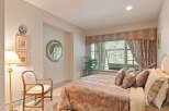 This inviting bedroom features a plush king-sized bed adorned with decorative pillows, perfect for a restful night's sleep.