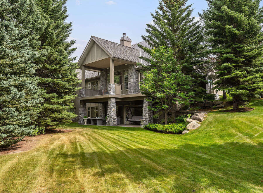 This stunning stone-clad home offers a luxurious retreat with multiple levels of outdoor living space.