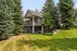 This stunning stone-clad home offers a luxurious retreat with multiple levels of outdoor living space.