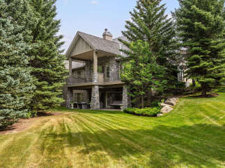 This stunning stone-clad home offers a luxurious retreat with multiple levels of outdoor living space.