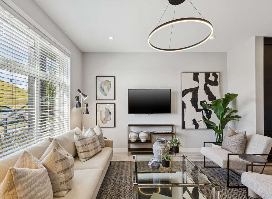 Experience modern living in this stylish living room, featuring a comfortable sectional sofa adorned with plush throw pillows.
