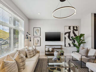 Experience modern living in this stylish living room, featuring a comfortable sectional sofa adorned with plush throw pillows.
