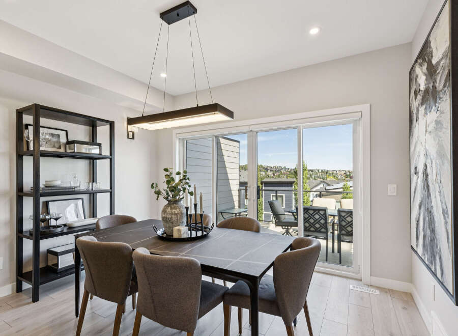 Experience elegant dining in this beautifully appointed space, featuring a sleek dark dining table complemented by plush upholstered chairs.