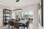 Experience elegant dining in this beautifully appointed space, featuring a sleek dark dining table complemented by plush upholstered chairs.