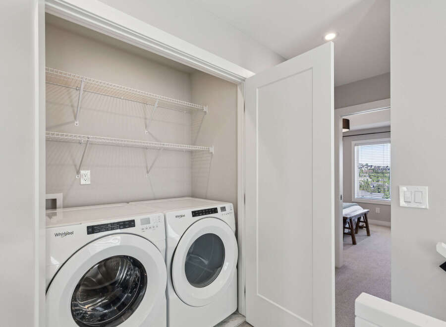 Discover convenient in-suite laundry with this modern Whirlpool washer and dryer set, neatly tucked away in a spacious closet.