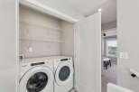 Discover convenient in-suite laundry with this modern Whirlpool washer and dryer set, neatly tucked away in a spacious closet.