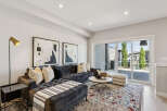 Experience modern living in this stylish living room, featuring a plush charcoal sectional sofa adorned with decorative pillows and a cozy throw.