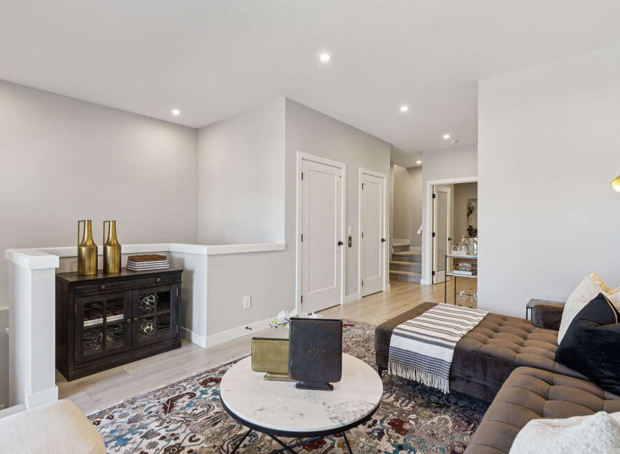 Step into this inviting living space, featuring a plush sectional sofa adorned with decorative pillows and a cozy throw.