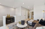 Step into this inviting living space, featuring a plush sectional sofa adorned with decorative pillows and a cozy throw.