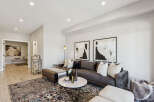 Step into this elegantly designed living room, featuring a plush tufted sectional sofa perfect for relaxation and entertaining.