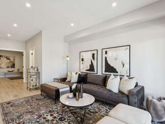 Step into this elegantly designed living room, featuring a plush tufted sectional sofa perfect for relaxation and entertaining.