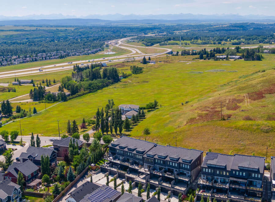 Discover modern townhome living with stunning mountain views in this aerial shot.
