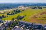 Discover modern townhome living with stunning mountain views in this aerial shot.