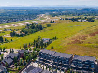 Discover modern townhome living with stunning mountain views in this aerial shot.
