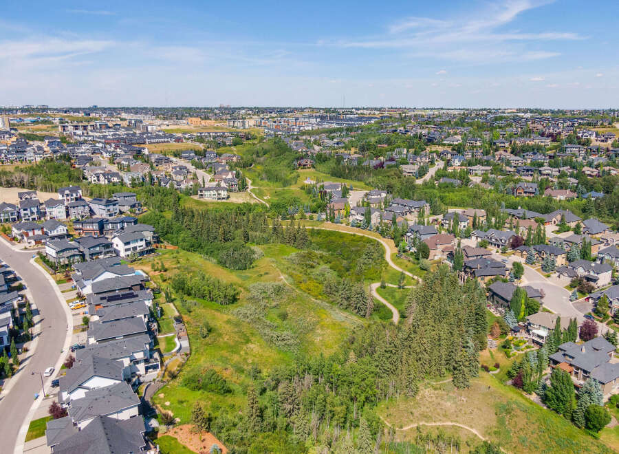 Discover this stunning aerial view of a modern suburban neighborhood, showcasing a harmonious blend of contemporary homes and lush green spaces.