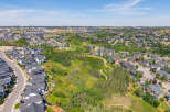 Discover this stunning aerial view of a modern suburban neighborhood, showcasing a harmonious blend of contemporary homes and lush green spaces.