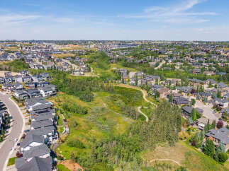 Discover this stunning aerial view of a modern suburban neighborhood, showcasing a harmonious blend of contemporary homes and lush green spaces.