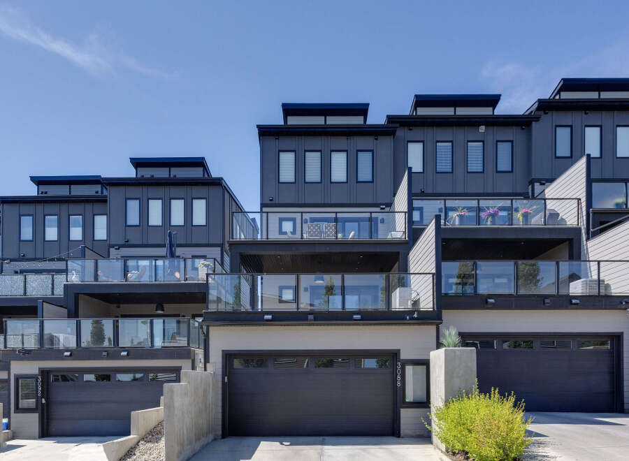 Discover modern living in this stunning townhouse complex featuring sleek architecture and multiple levels of outdoor living space.