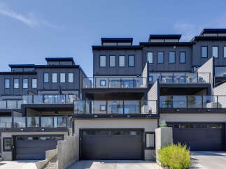Discover modern living in this stunning townhouse complex featuring sleek architecture and multiple levels of outdoor living space.