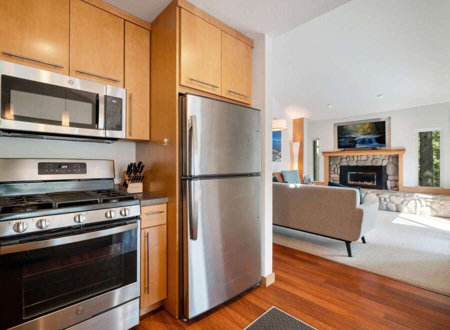 Experience modern living in this beautifully appointed kitchen, featuring sleek stainless steel appliances including a gas range and a microwave.