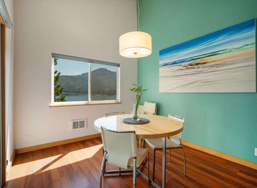 Enjoy breathtaking lake and mountain views from this charming dining area, perfect for intimate meals or morning coffee.