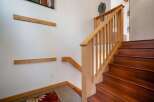 Ascend to the upper levels of this stunning home via a beautifully crafted wooden staircase, featuring rich, dark wood treads and a light wood banister.