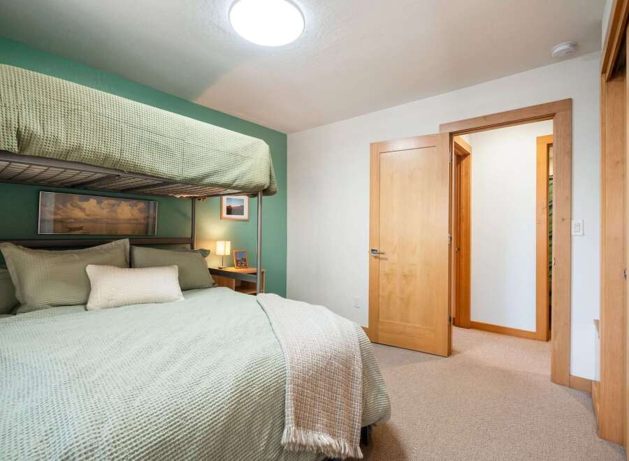 This cozy bedroom features a practical bunk bed setup, perfect for families or accommodating guests.