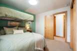 This cozy bedroom features a practical bunk bed setup, perfect for families or accommodating guests.